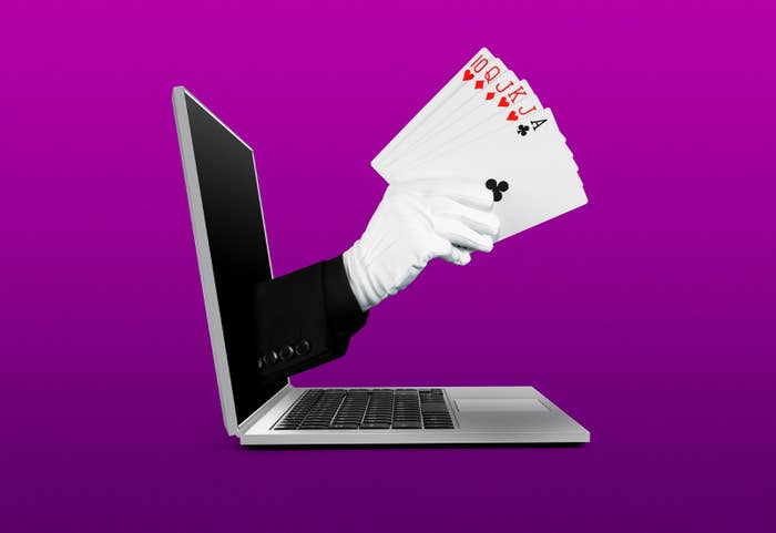 An illustration of a gloved hand holding playing cards extends from a laptop screen, as if by magic