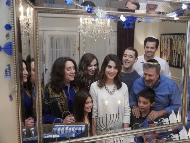 Rebecca and her family celebrating Hanukkah