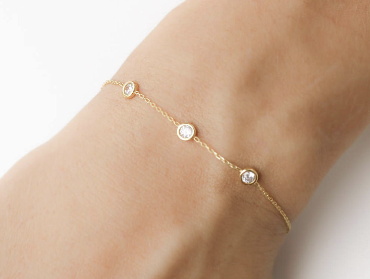 Model wearing bracelet with three stones