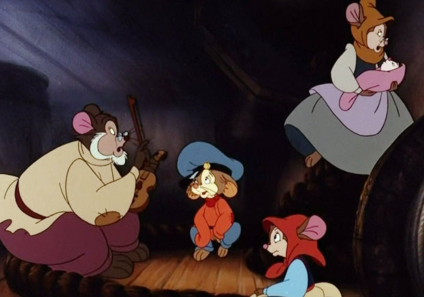 Fievel sitting with his family listening to his father speak 