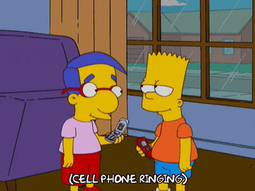 A GIF of Bart Simpson answering his cellphone that is ringing