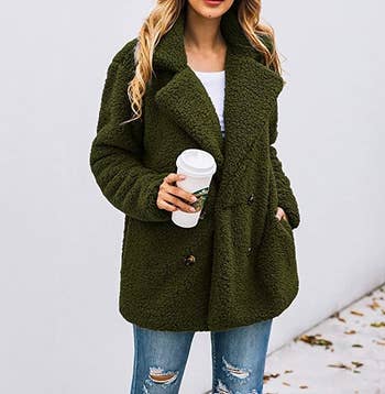 model wearing the teddy jacket with buttons, large lapel, and green color