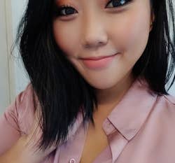 Asian reviewer wearing a light pink shade on their cheeks