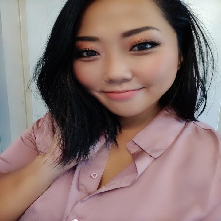 Asian reviewer wearing a light pink shade on their cheeks