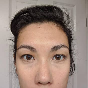 The same reviewer wearing the concealer, which has brightened the under-eye area