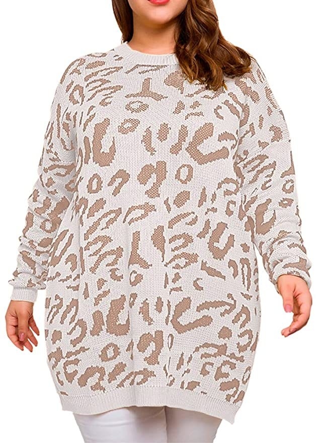 model wearing the long, oversized sweater in a white/beige leopard print