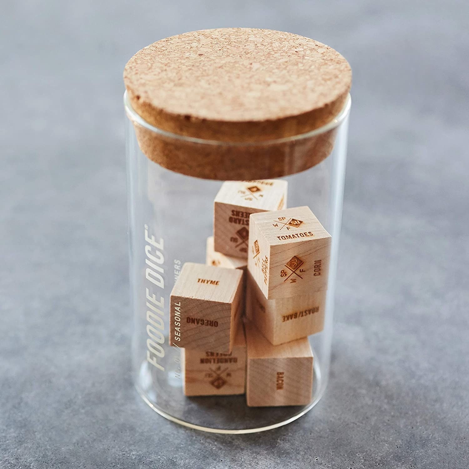 jar with cork top filled with wooden dice 
