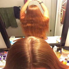 Reviewer with waist-length shiny red hair