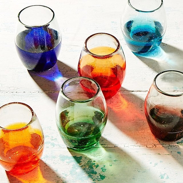 Stemless wine glasses with the bottom halves tinted in various colors