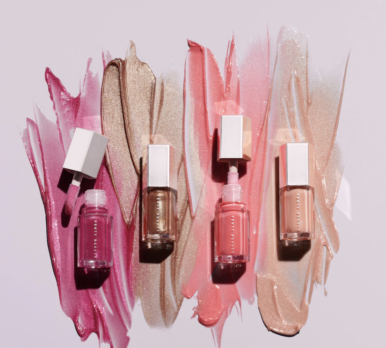 The lip gloss tubes in cranberry, brown, pink, and nude shades