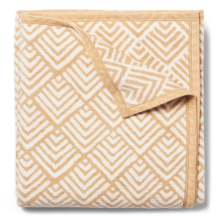 the blanket's scalloped stripe-y pattern