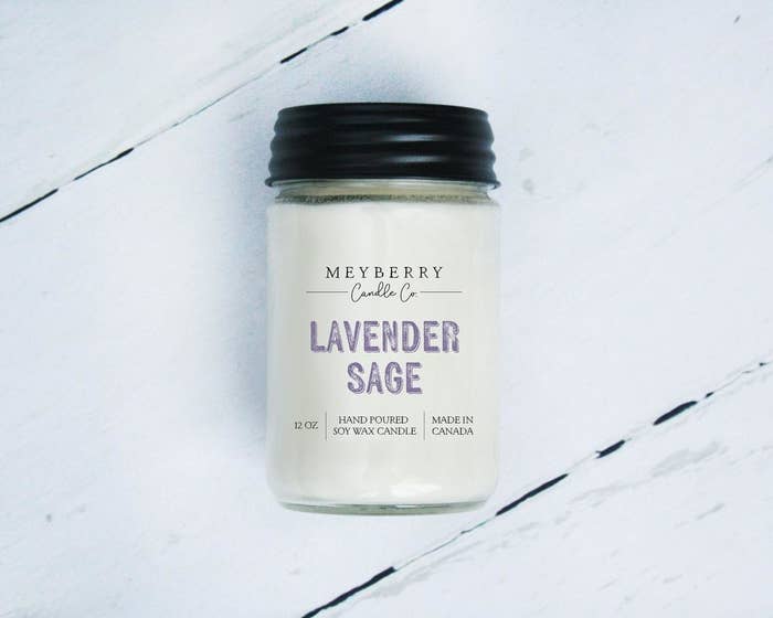 A candle on a table that says lavender sage