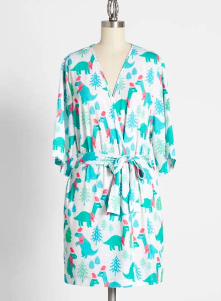 A robe with dinosaurs wearing Santa hats