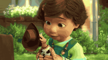 a gif of bonnie from toy story hugging a woody doll
