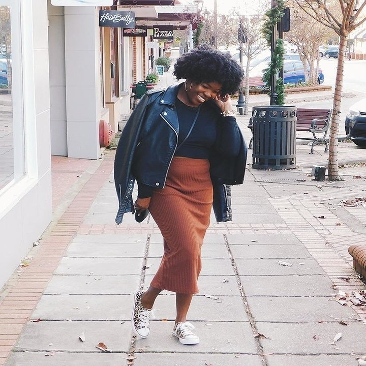 Reviewer wearing the mid-calf length ribbed skirt in orange