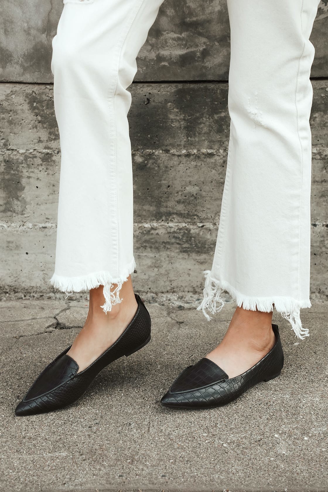 feet in black pointed loafers with vegan suede fabric 