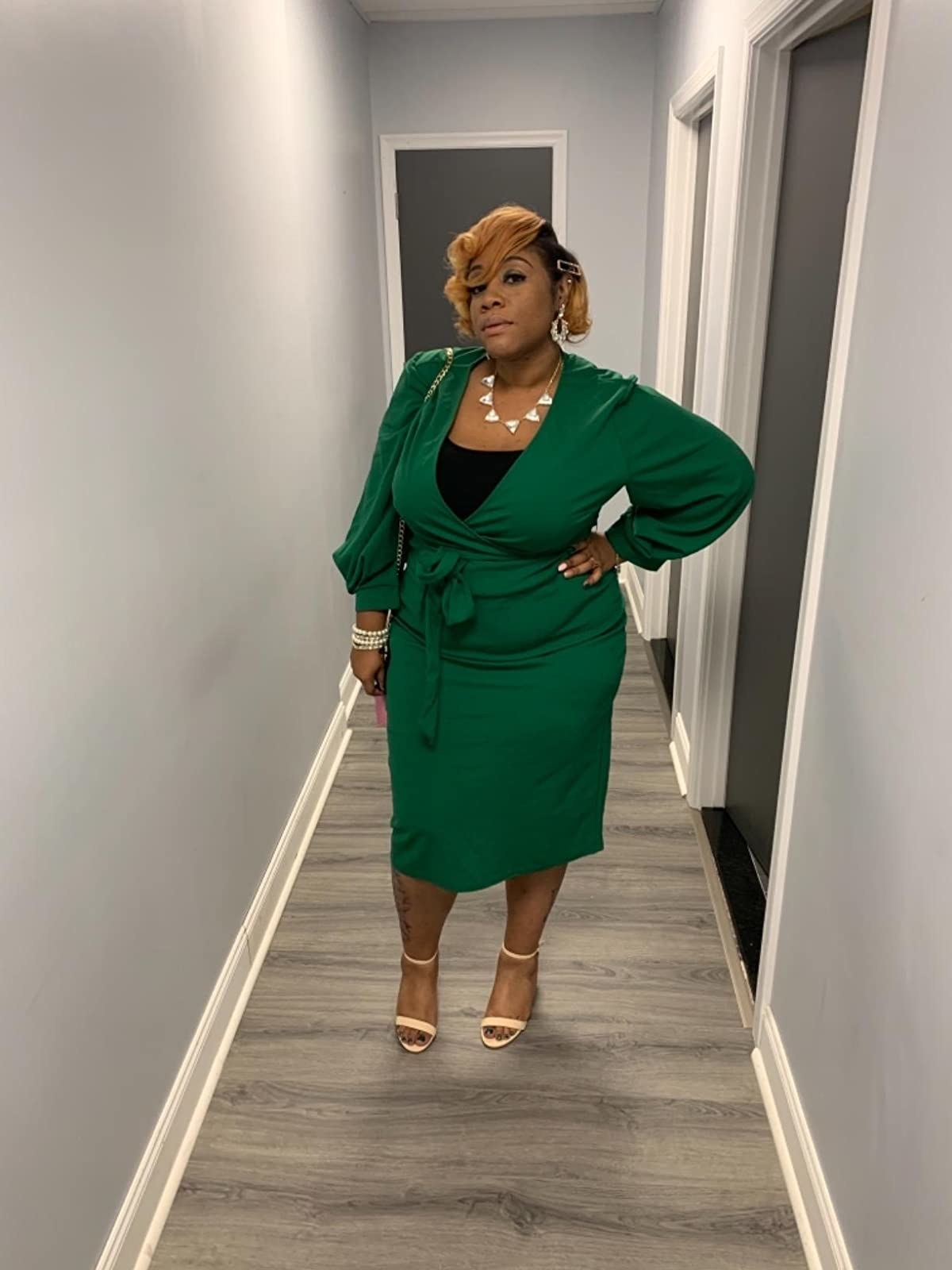 Reviewer wearing the deep v-neck wrap dress in green