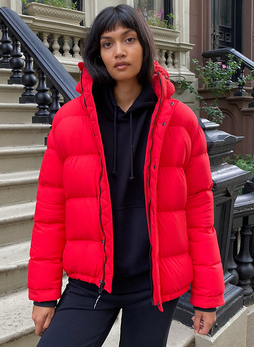 model wearing the red puffer jacket