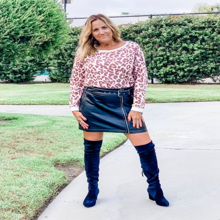 A different reviewer wearing the sweatshirt in pink leopard print