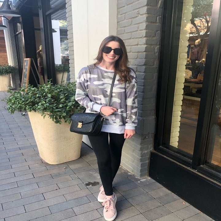 Reviewer wearing the sweatshirt in a grey camo print