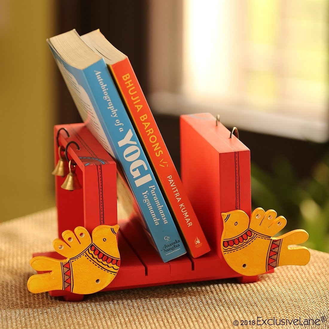 Bookends with birds on them and two books in the center
