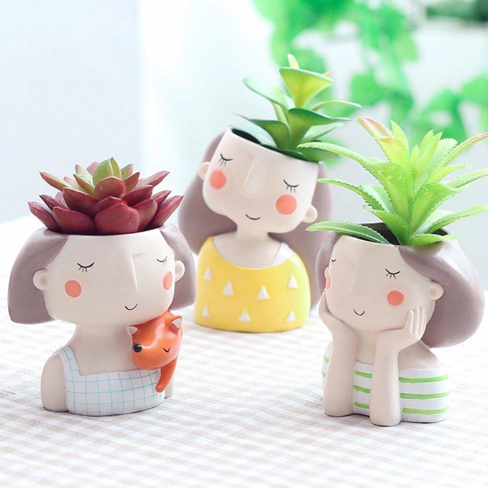 A set of planters shaped as smiling women
