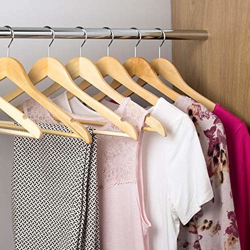 Clothes hung up on the wooden hangers.