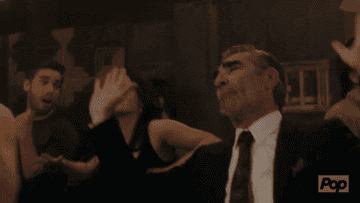 Gif of Johnny Rose from Schitt&#x27;s Creek dancing with his hands up