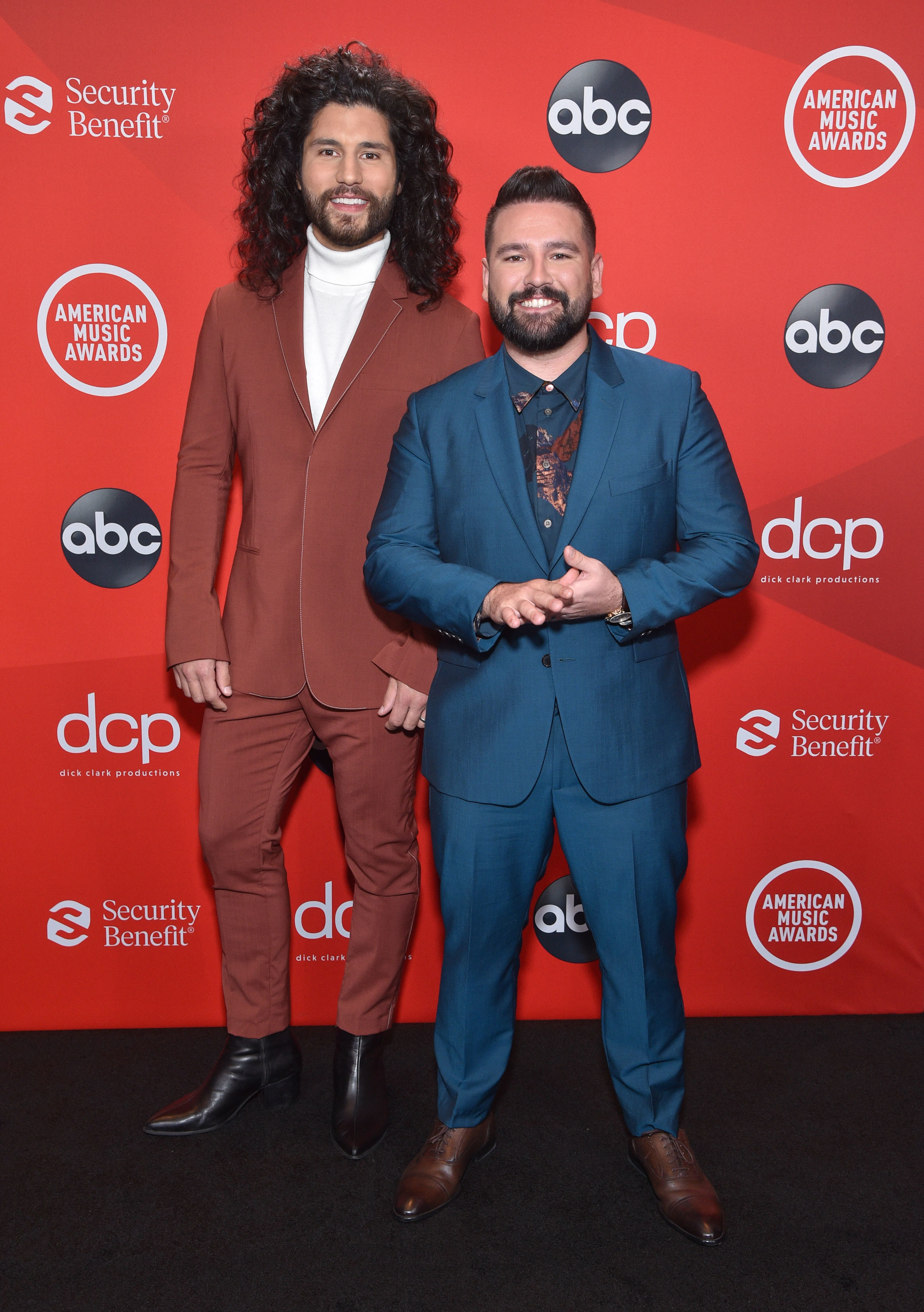 Dan Smyers and Shay Mooney of Dan + Shay wearing suits