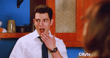 Gif of Schmidt and Nick looking shocked and excited on New Girl