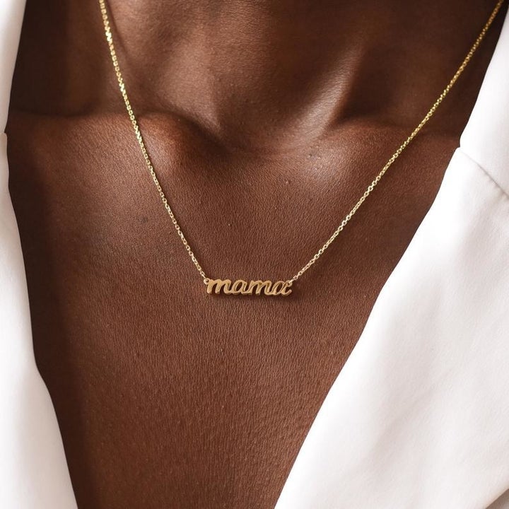 person wearing "mama" necklace