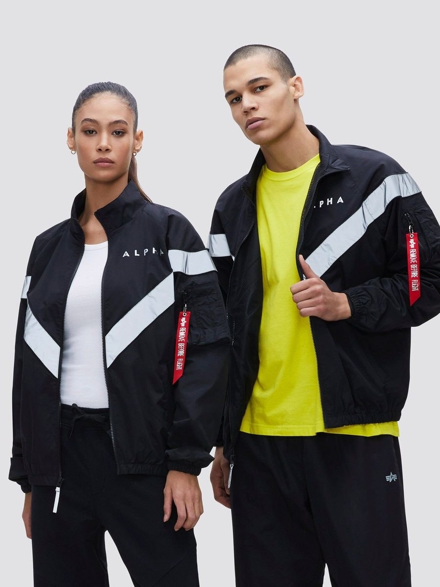 two models wear the pt track jacket in black