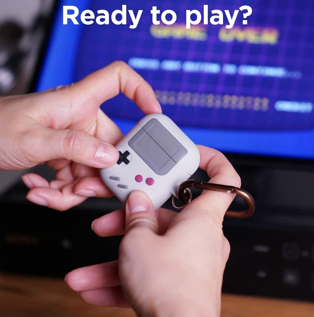 A person pretending to play on the game controller-shaped airpod case