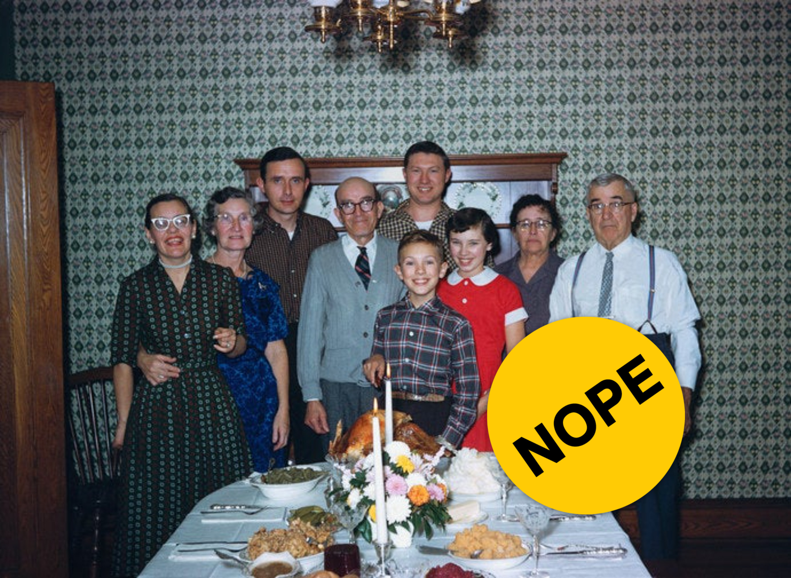 Multi-generational family standing behind a thanksgiving table with &quot;Nope&quot; label photoshopped on top. 