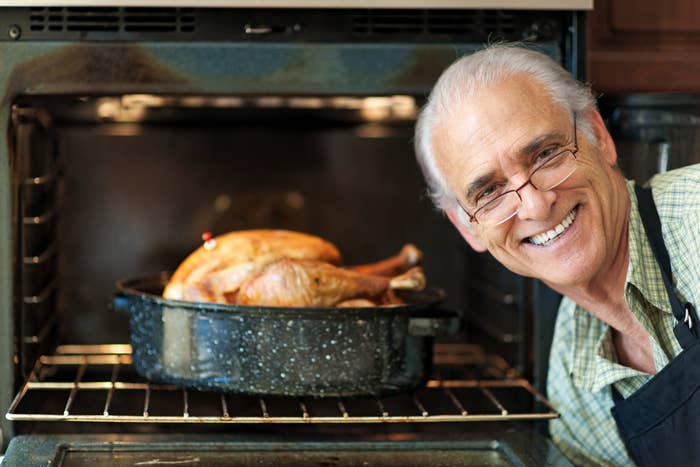 Proud single senior man cooking turkey