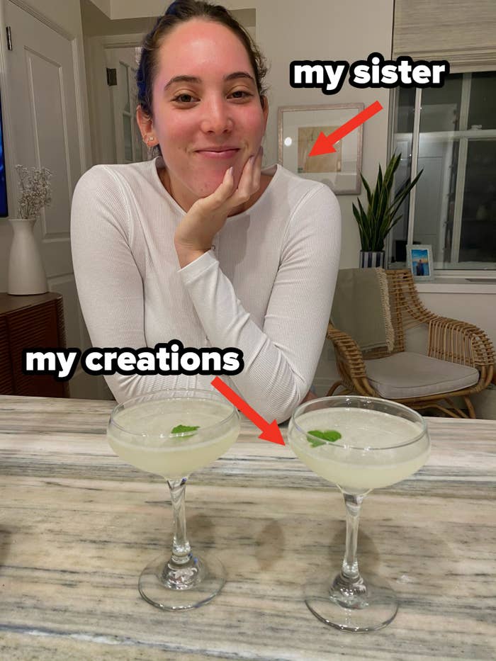 My sister posing with two sake cocktails.
