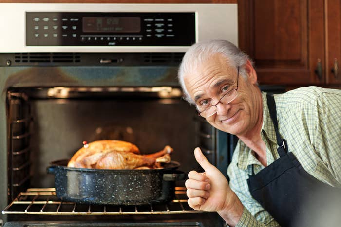 Proud single senior man cooking turkey