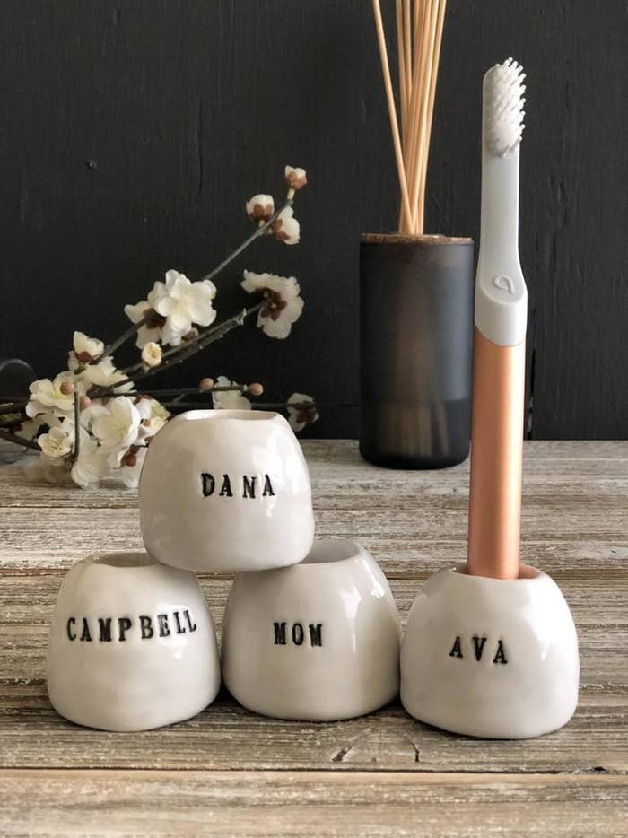 Four toothbrush holders with names on them