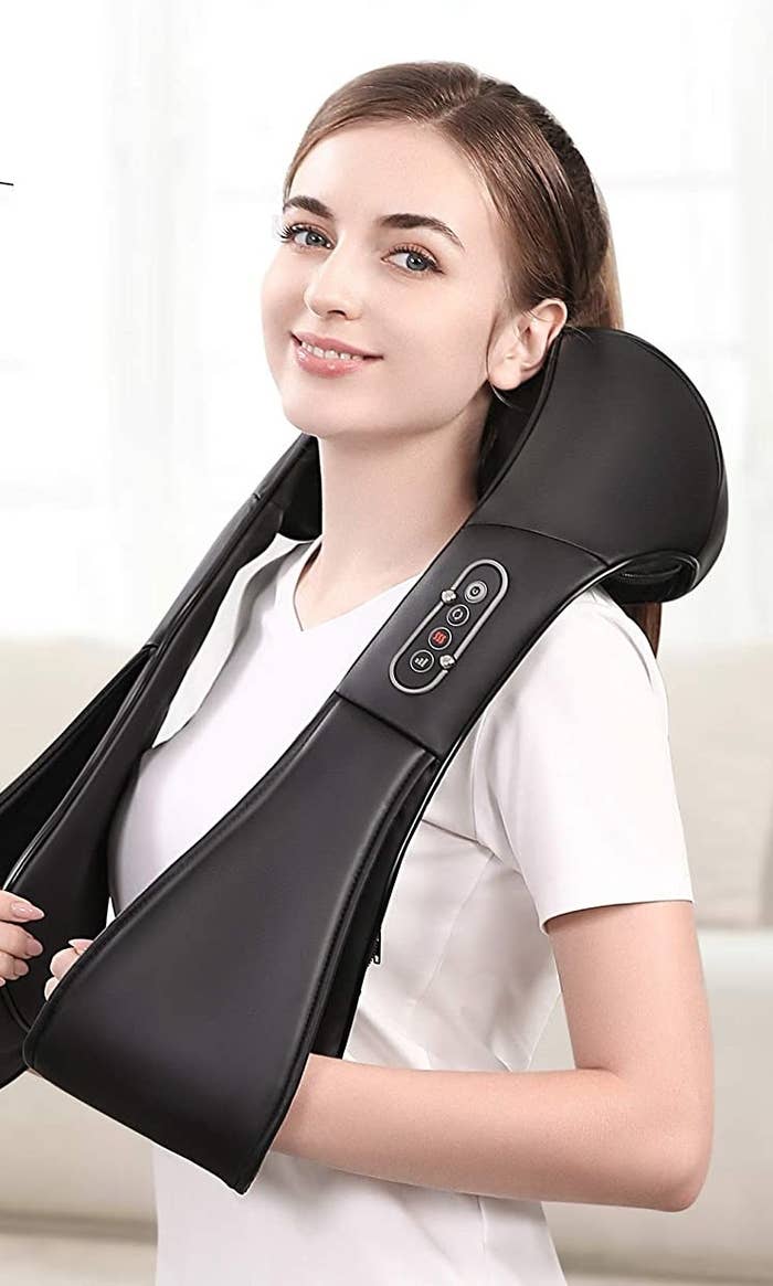 woman using the massager around her neck