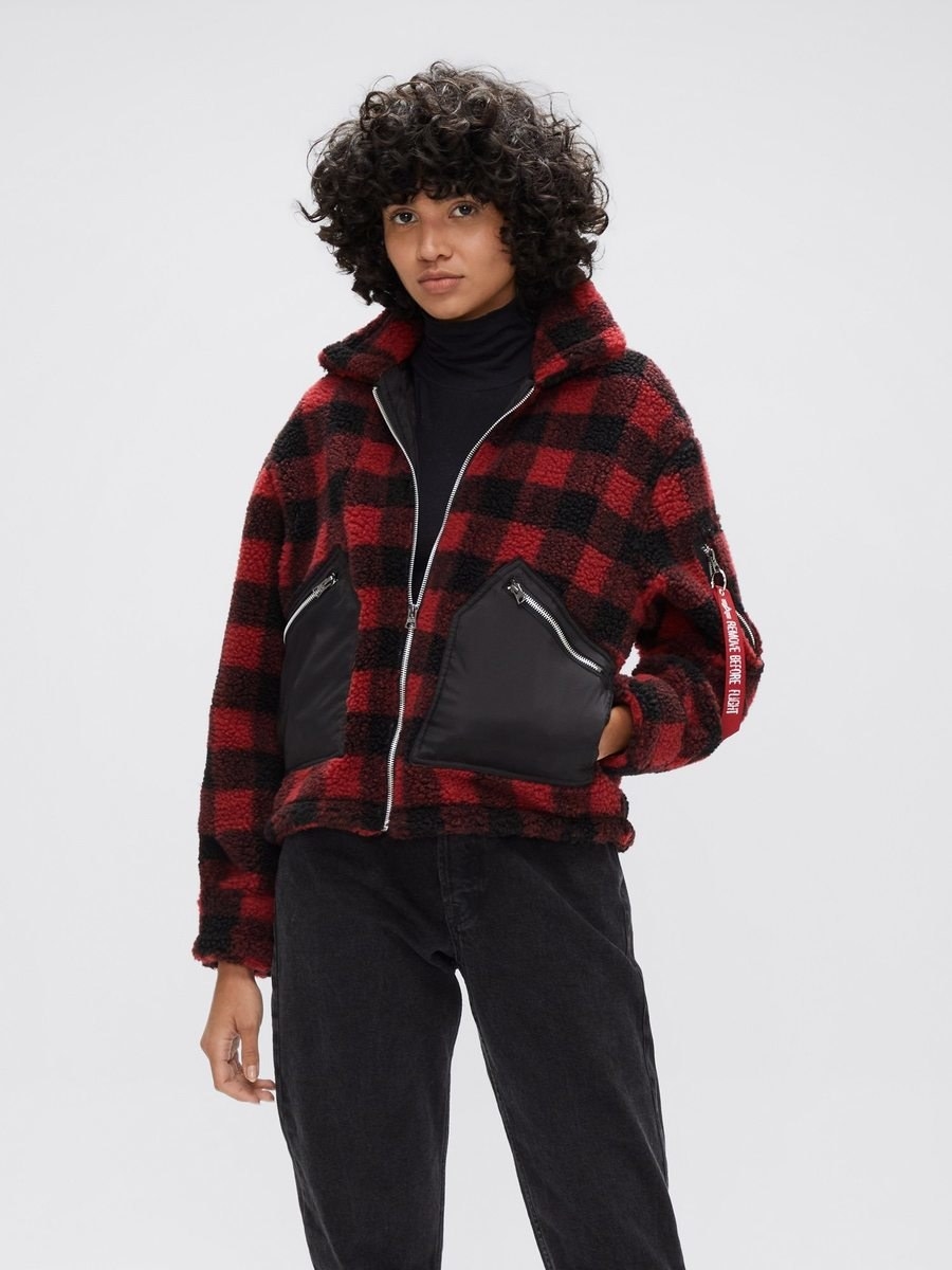 a model wears the cropped sherpa utility jacket in red plaid