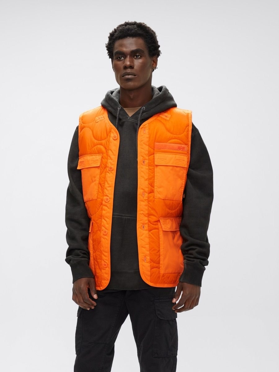 a model wears the als utility vest