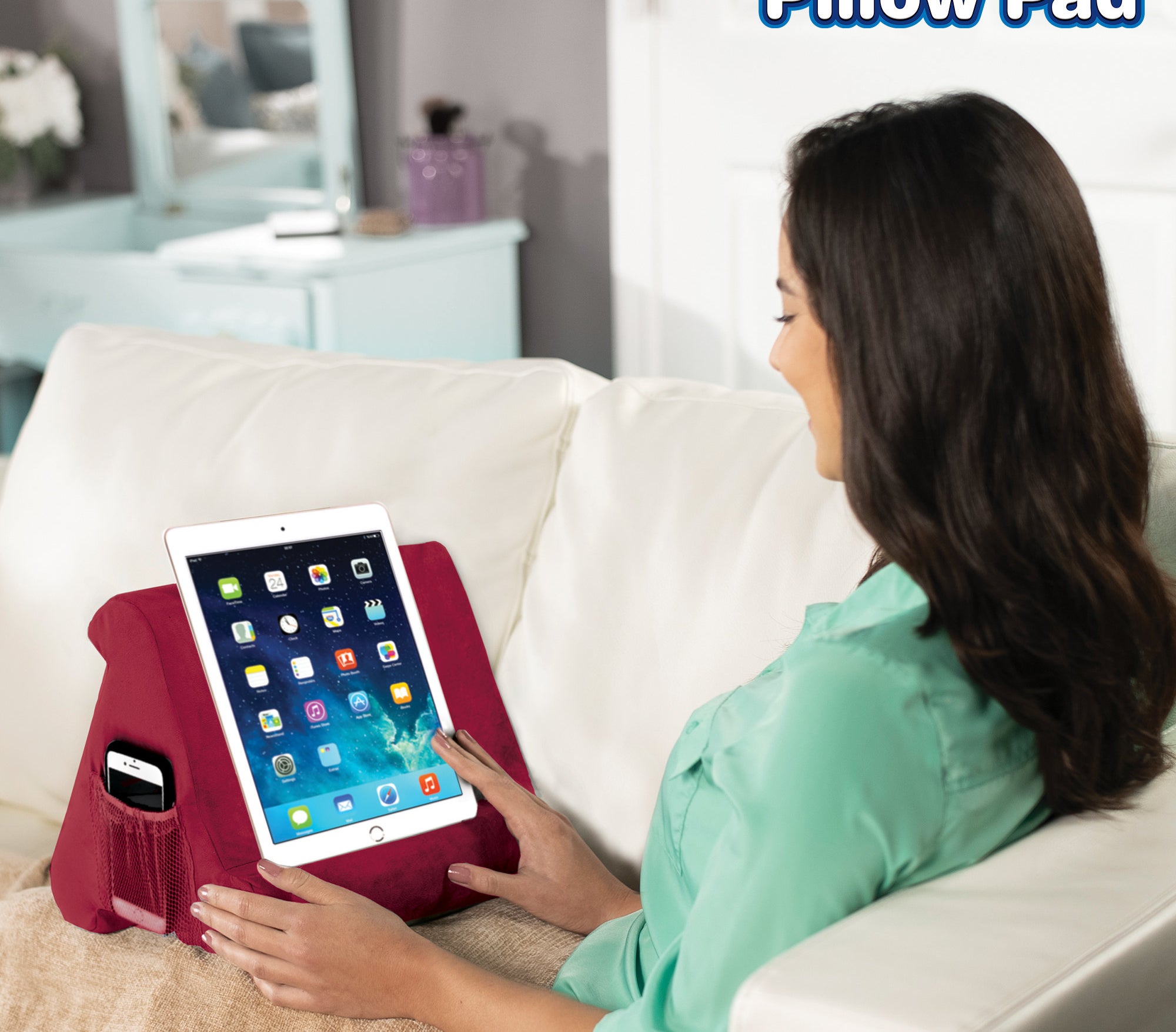 person using a burgundy pillow pad to use her ipad