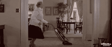 Mrs. Doubtfire dances with a vacuum