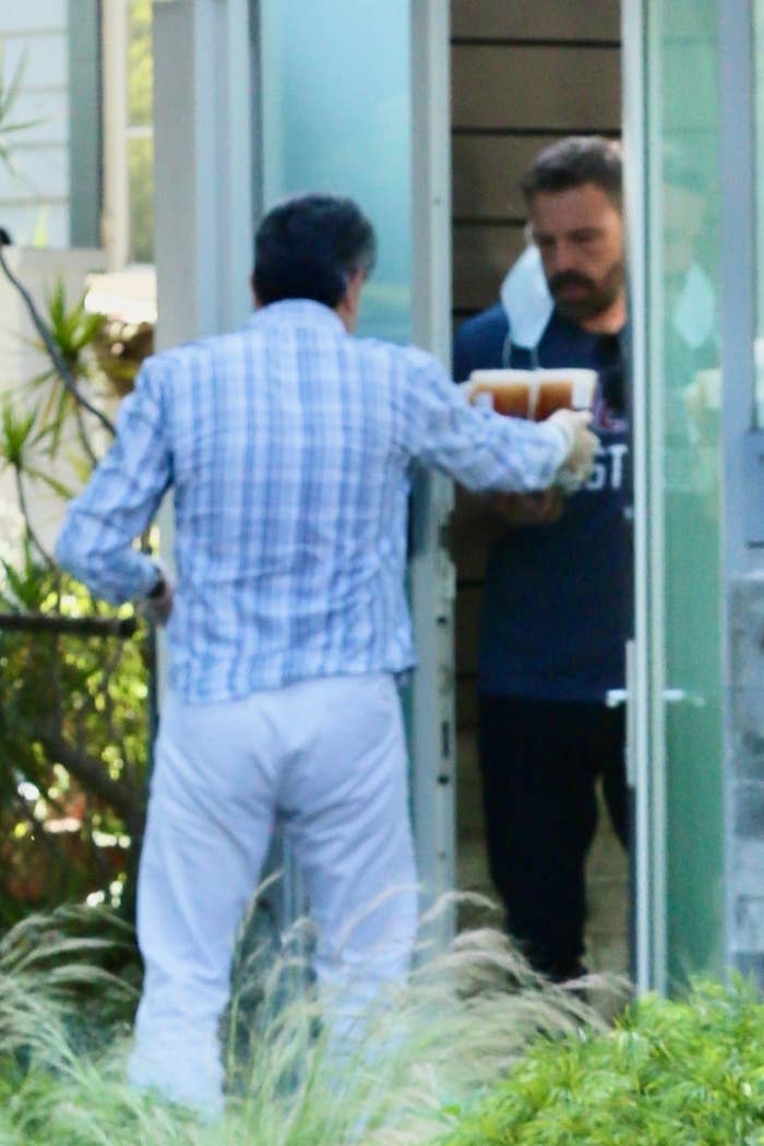 Ben getting four iced coffees from a delivery person