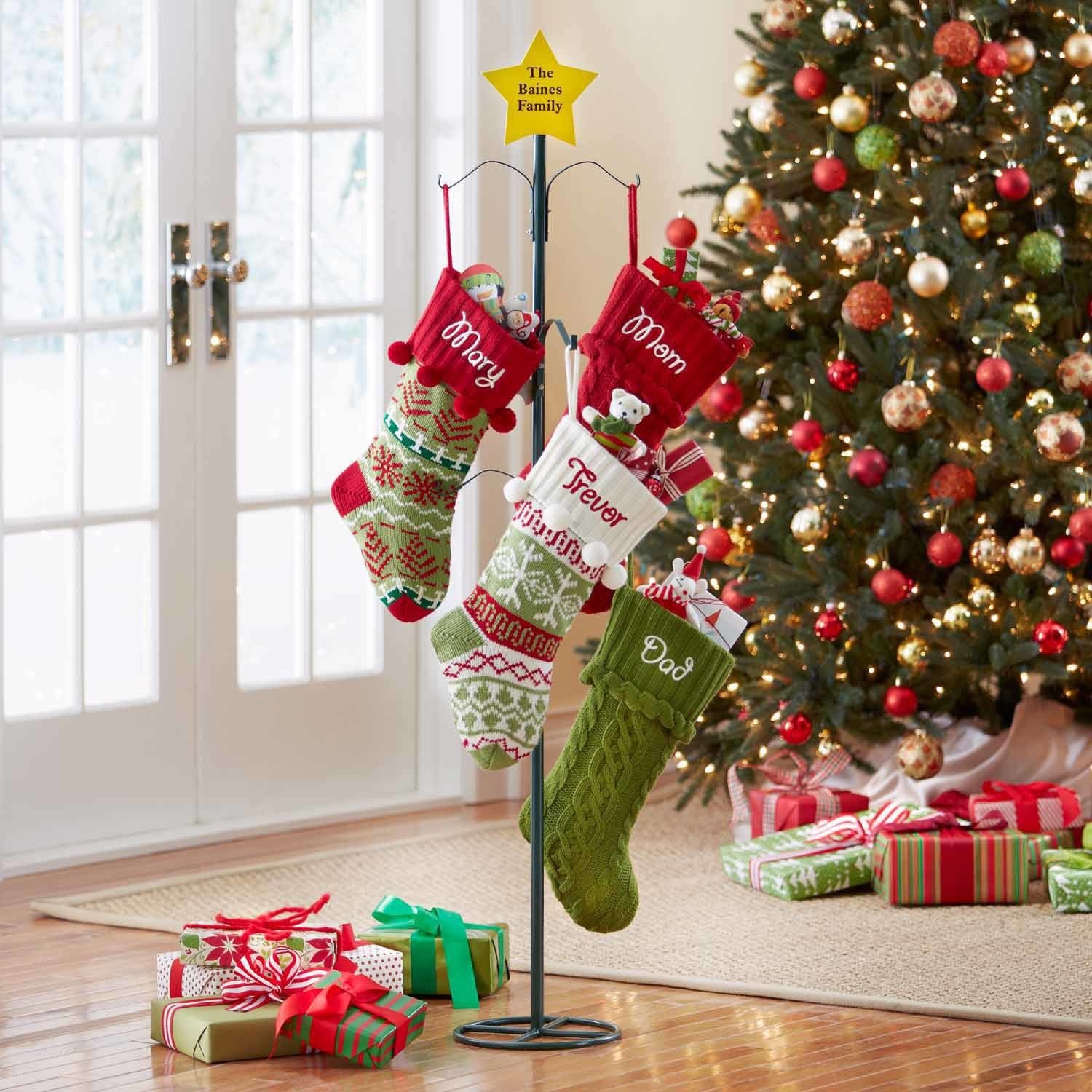The stocking holder with a personalized star at the top holding four stockings