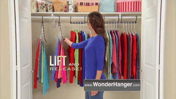 person using WonderHanger system to increase hanging space in closet
