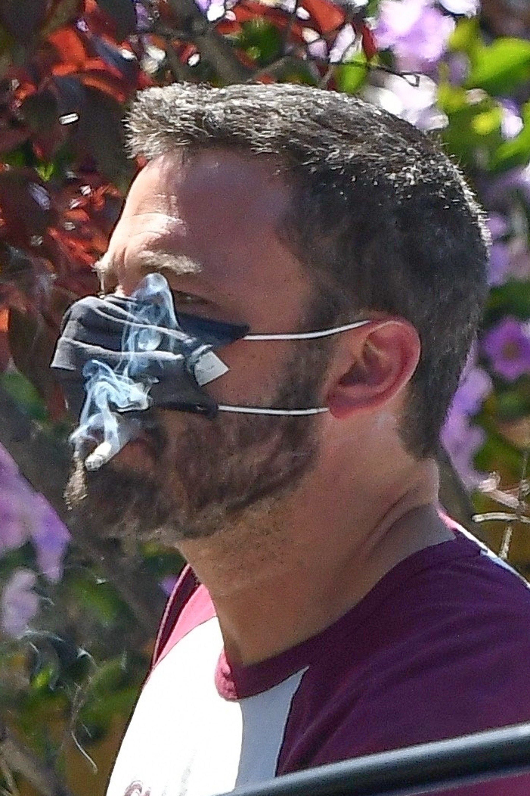 ben smoking a cig through his mask