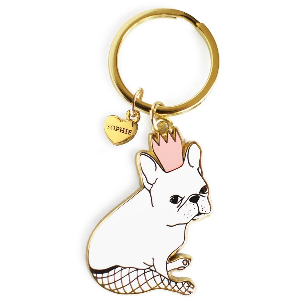 White French bulldog wearing fishnet tights and a pink crown on a keychain