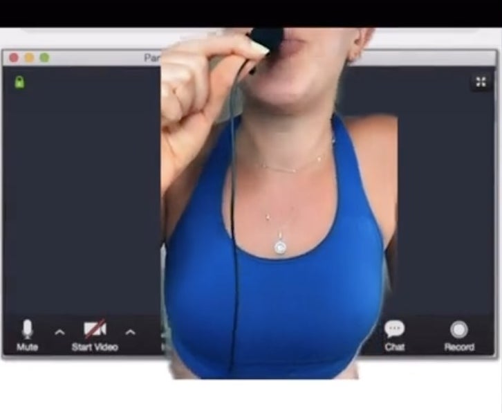 A woman pretending to take up the entire Zoom screen with her body