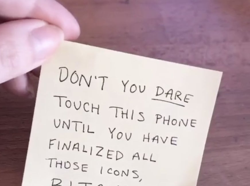 A post it note that says "don't you dare touch this phone until you have finalized all those icons"